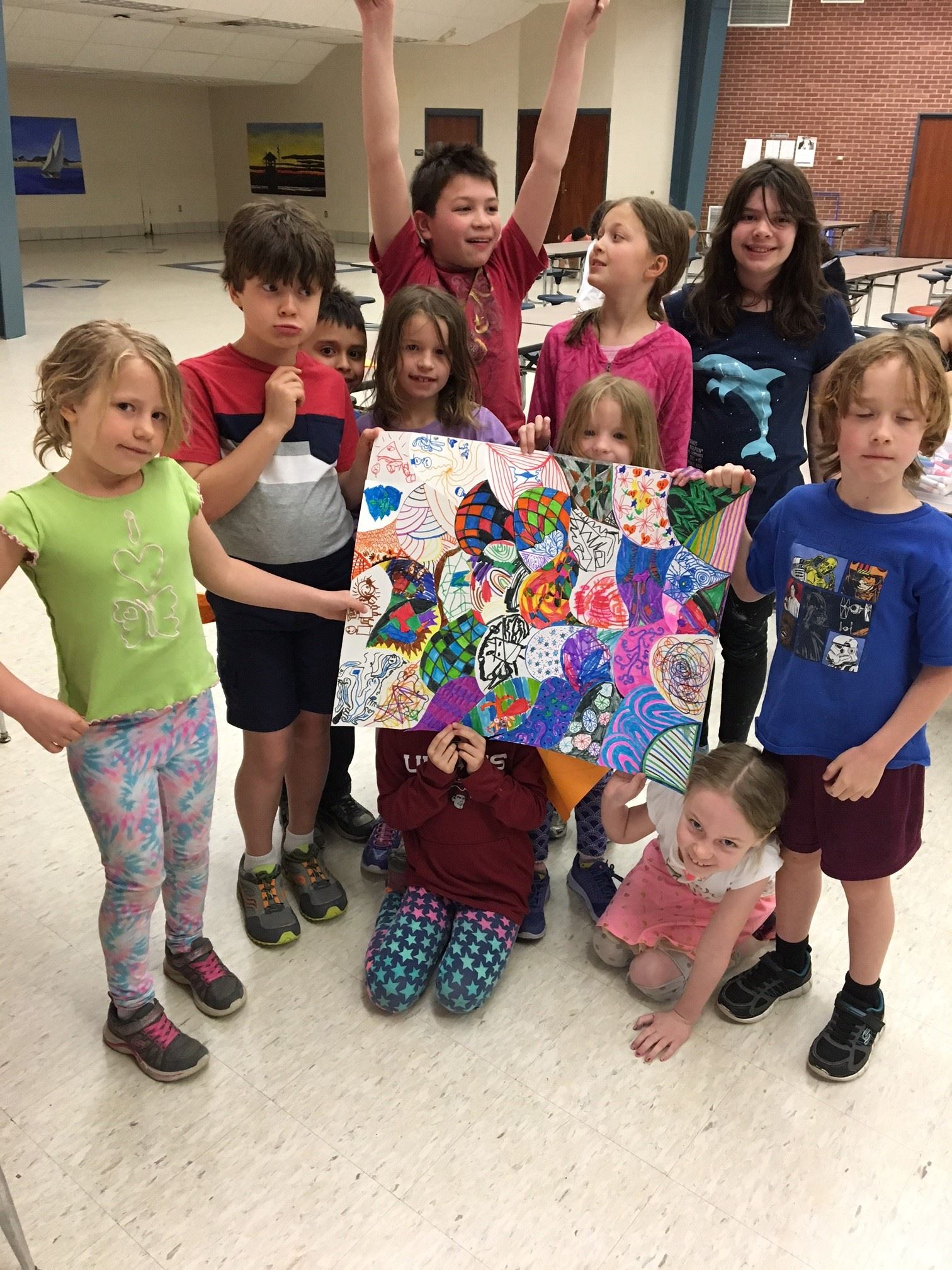Young kids holding a painting